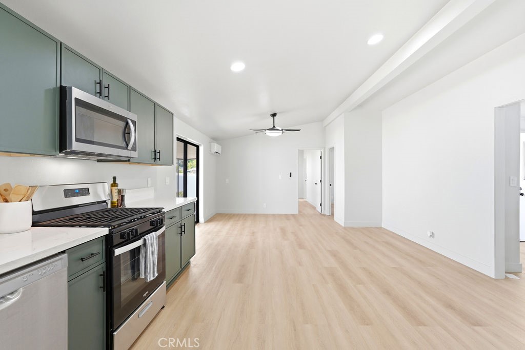 15181 Van Buren, Unit 262 Riverside, CA 92504 - Photo 9 of 48 a kitchen with stainless steel appliances granite countertop a stove and a sink