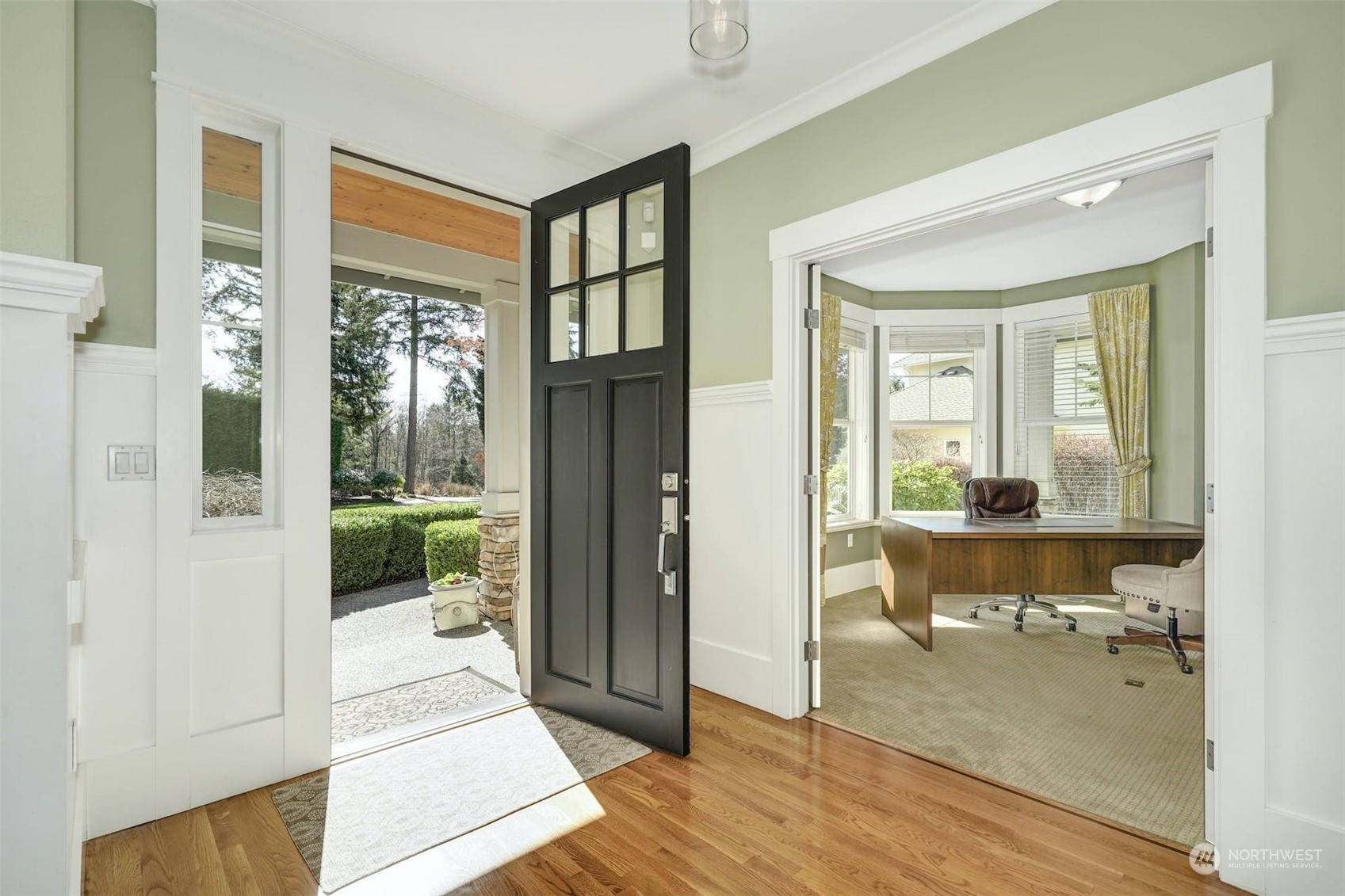 20628 Southeast 162nd Way Renton, WA 98059 - Photo 2 of 25 a view of a hallway with wooden floor and a living room