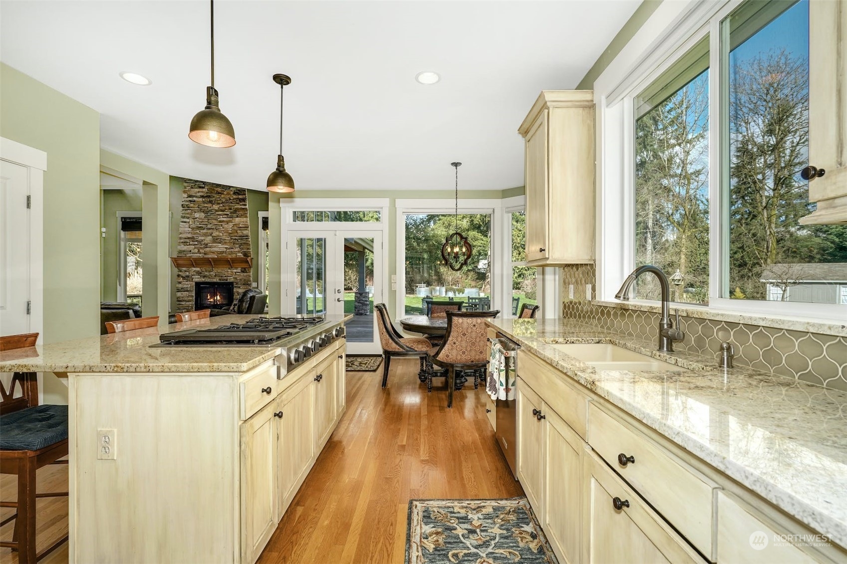 20628 Southeast 162nd Way Renton, WA 98059 - Photo 5 of 25 a large kitchen with kitchen island granite countertop a large window and stainless steel appliances
