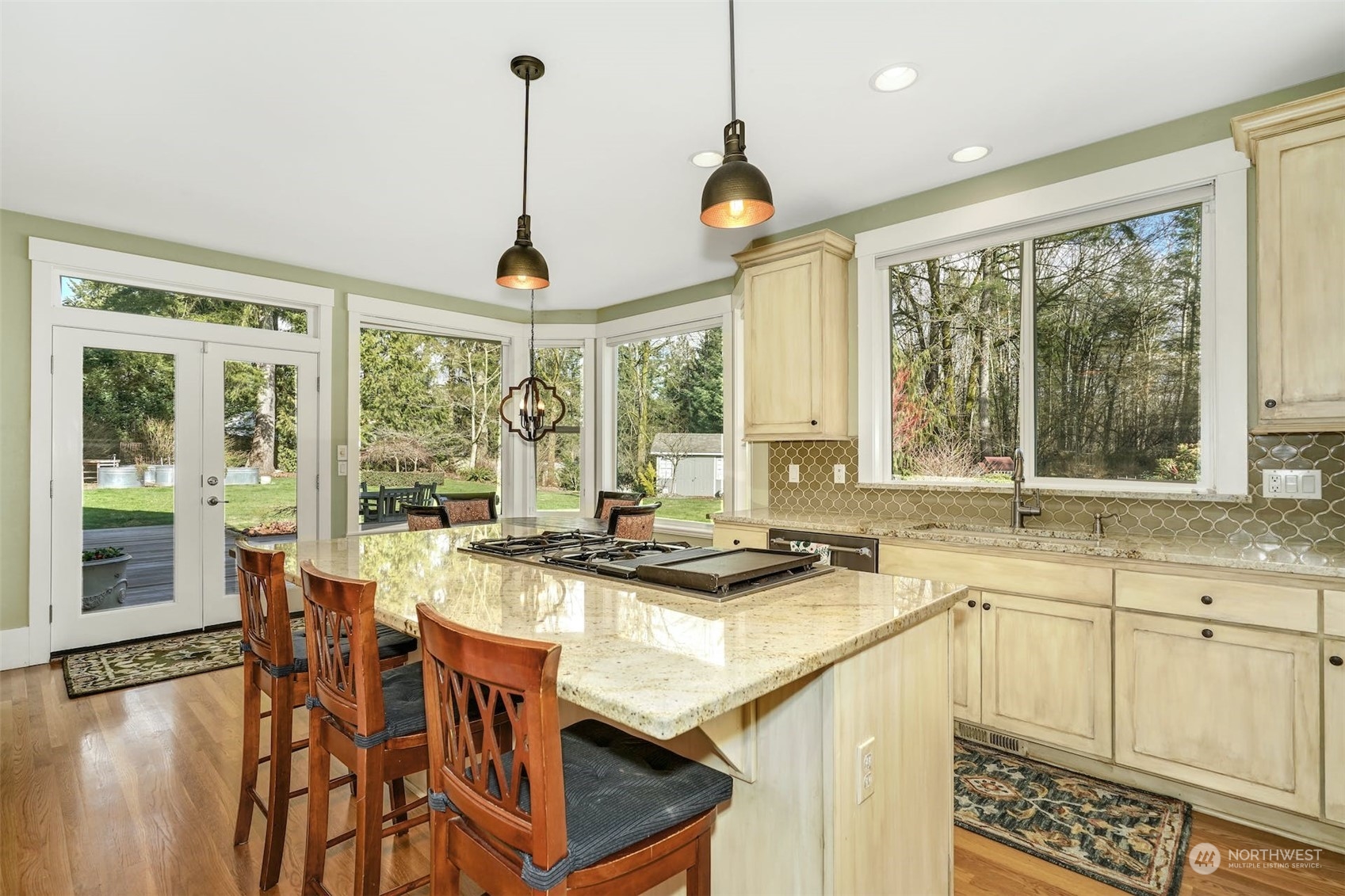 20628 Southeast 162nd Way Renton, WA 98059 - Photo 6 of 25 a kitchen with stainless steel appliances granite countertop a stove a sink and a dining table with the view of living room