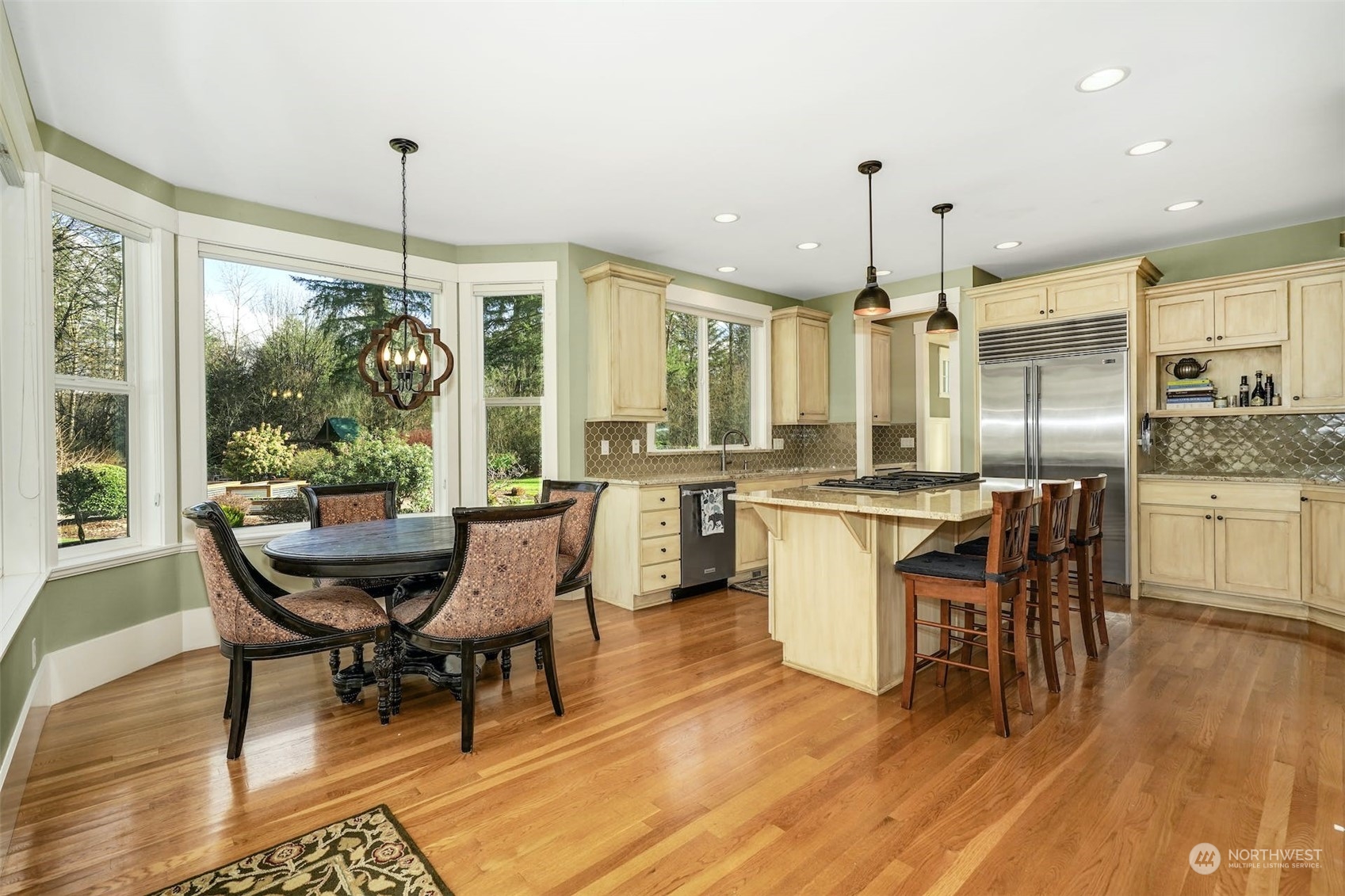 20628 Southeast 162nd Way Renton, WA 98059 - Photo 7 of 25 a dining room with furniture a chandelier and wooden floor