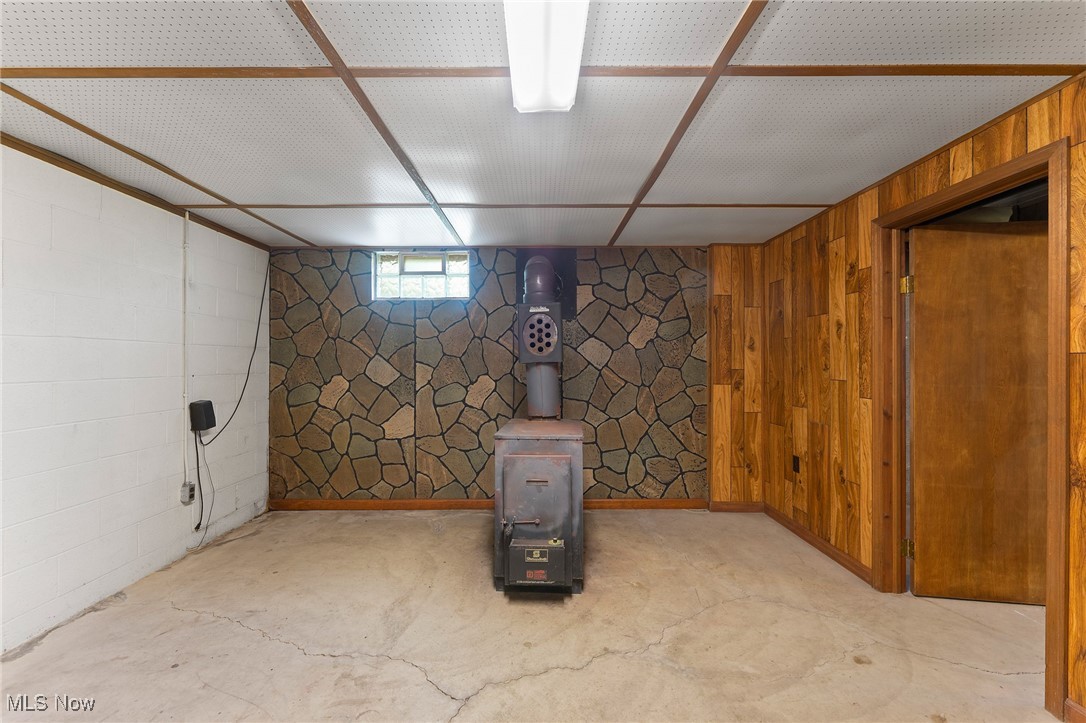 744 Johnson Plank Road Warren, OH 44481 - Photo 23 of 39 Below grade area featuring wood walls and wood burner.