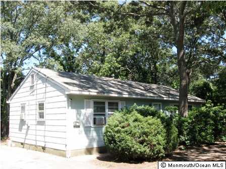 2111 Rogers Road Point Pleasant, NJ 08742 - Photo 1 of 3 a front view of a house with a garden