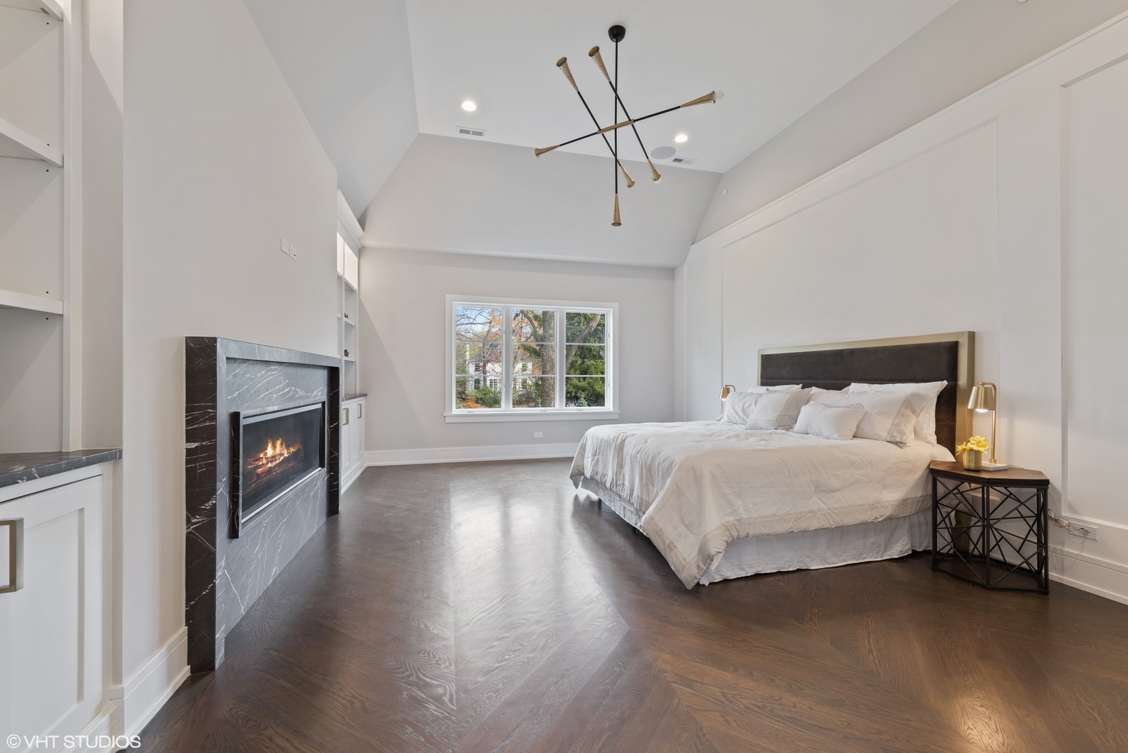 885 Private Road Winnetka, IL 60093 - Photo 15 of 35 a spacious bedroom with a bed and a fireplace