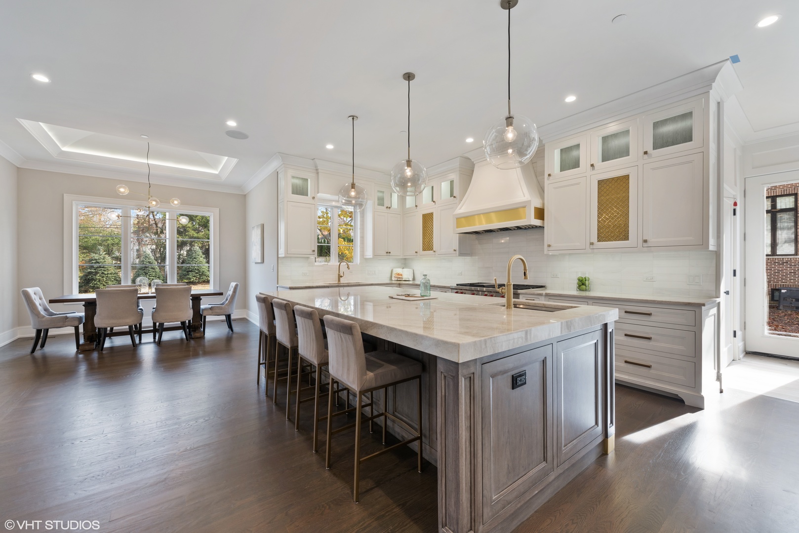 885 Private Road Winnetka, IL 60093 - Photo 9 of 35 a kitchen with kitchen island granite countertop a stove a sink a island and chairs