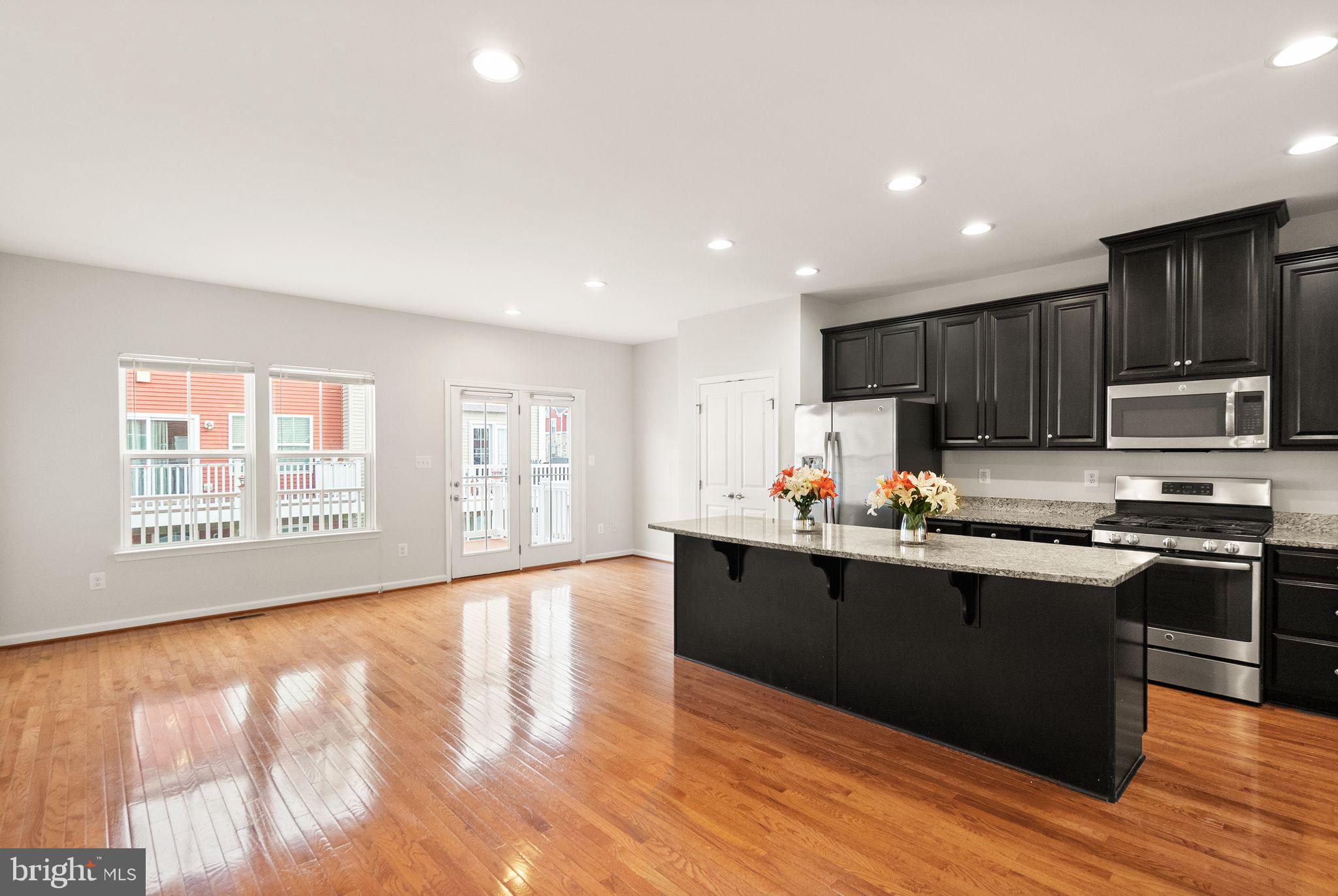 41688 McMonagle Square Aldie, VA 20105 - Photo 20 of 59 a kitchen with stainless steel appliances granite countertop a stove a sink and a refrigerator