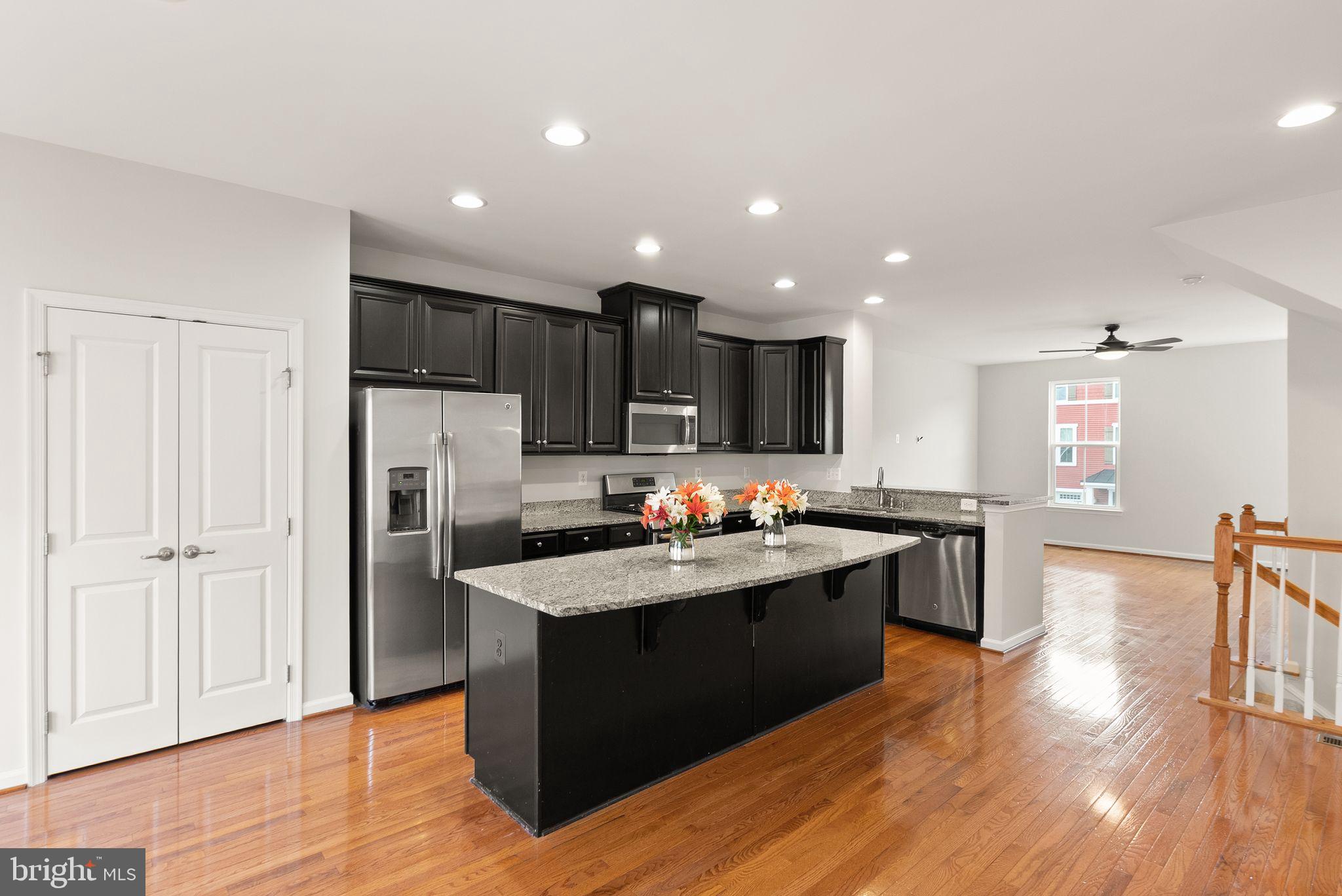 41688 McMonagle Square Aldie, VA 20105 - Photo 25 of 59 a kitchen with kitchen island sink stove and refrigerator
