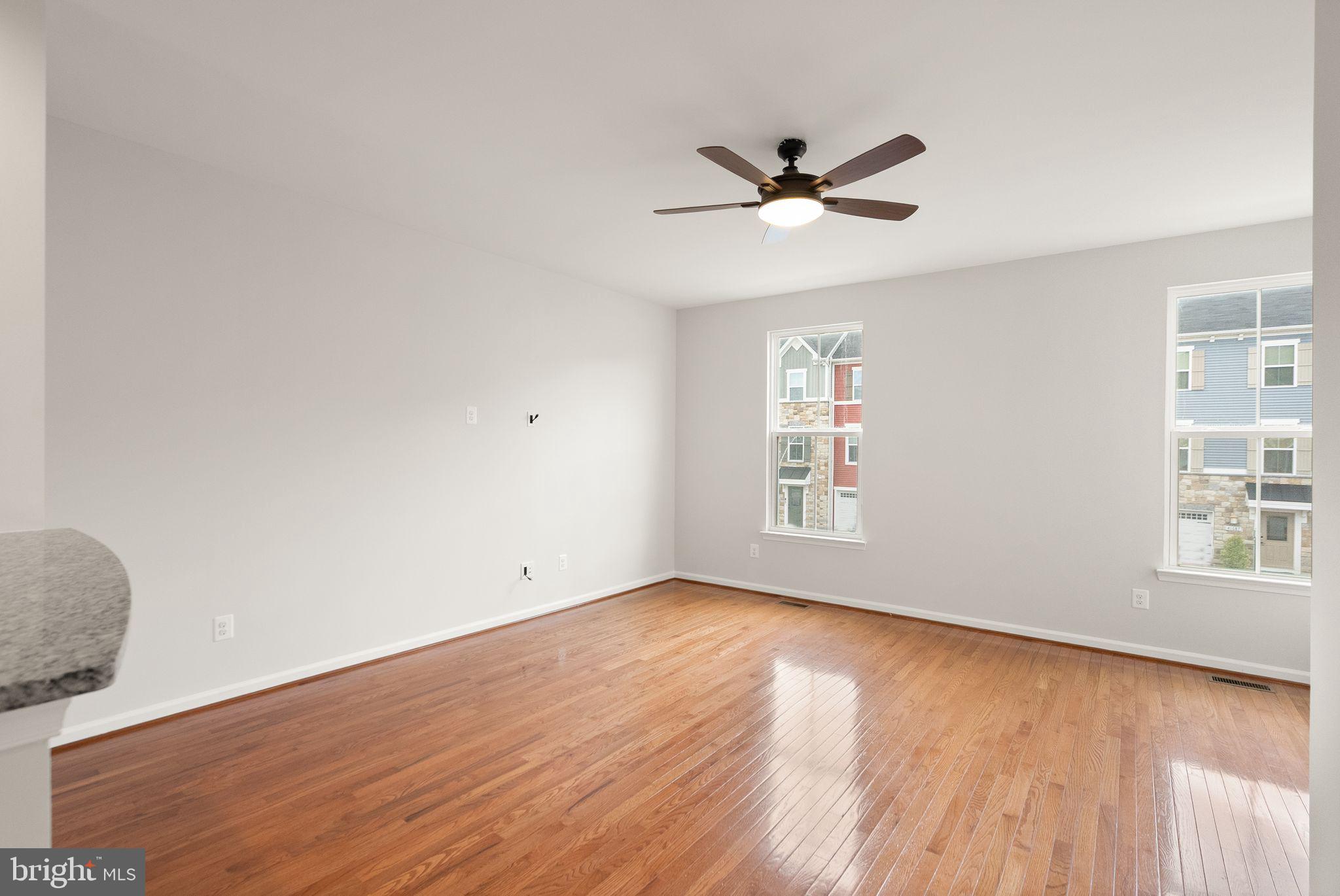 41688 McMonagle Square Aldie, VA 20105 - Photo 31 of 59 a view of an empty room with wooden floor and a window