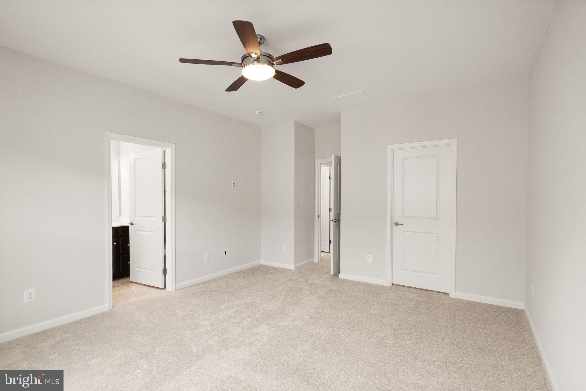 41688 McMonagle Square Aldie, VA 20105 - Photo 39 of 59 an empty room with closet and ceiling fan