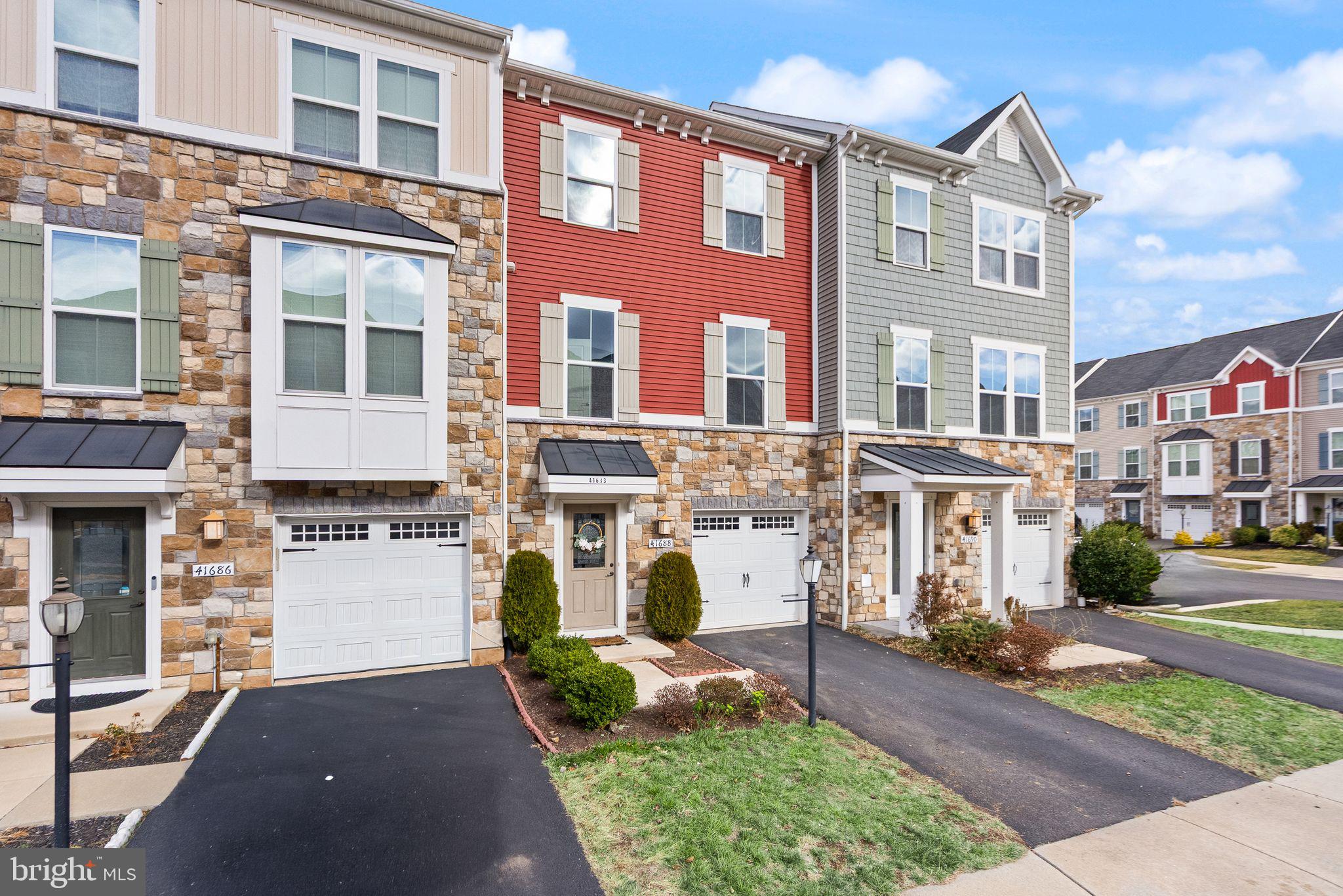 41688 McMonagle Square Aldie, VA 20105 - Photo 4 of 59 a front view of a house with a yard