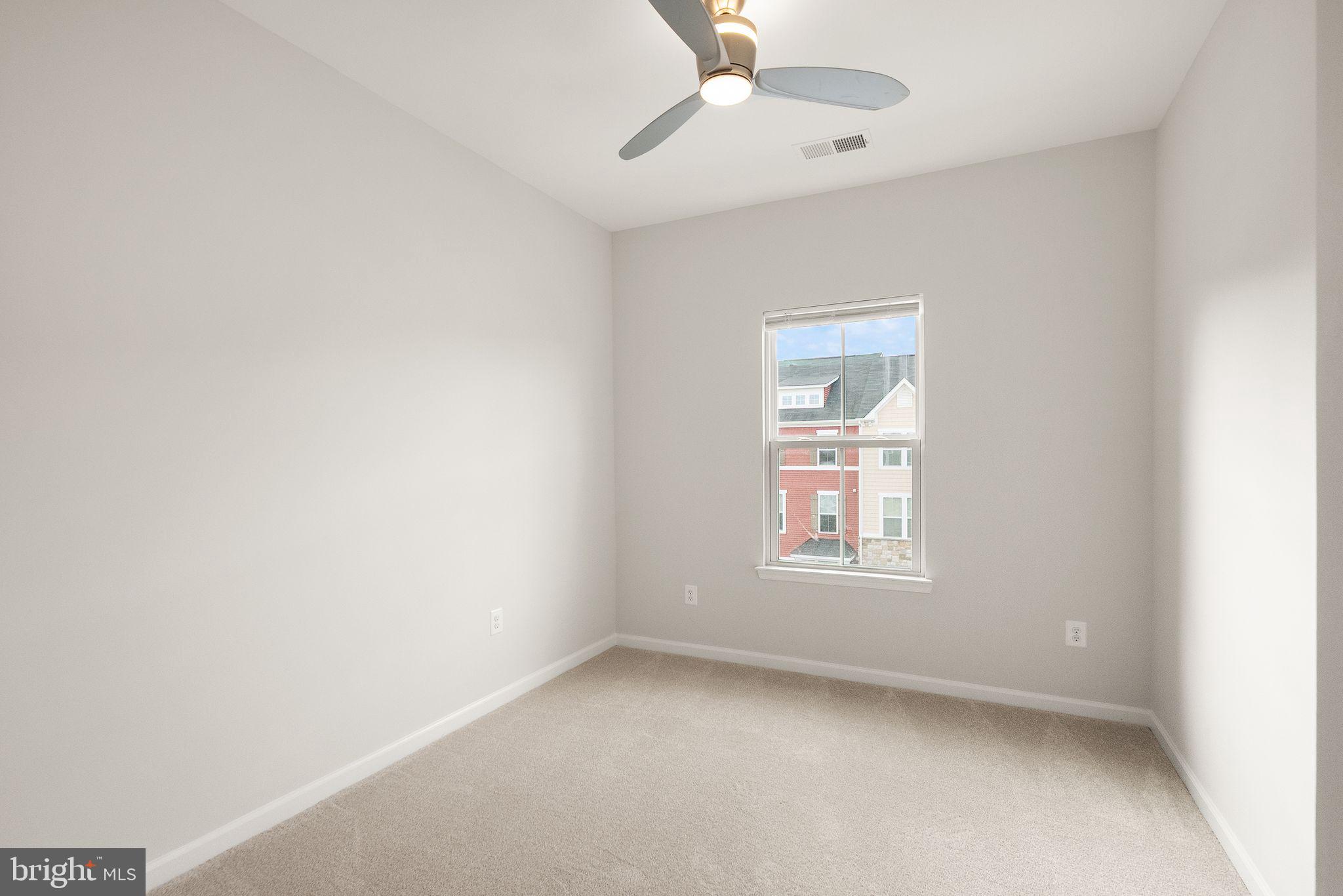 41688 McMonagle Square Aldie, VA 20105 - Photo 48 of 59 an empty room with a window and ceiling fan