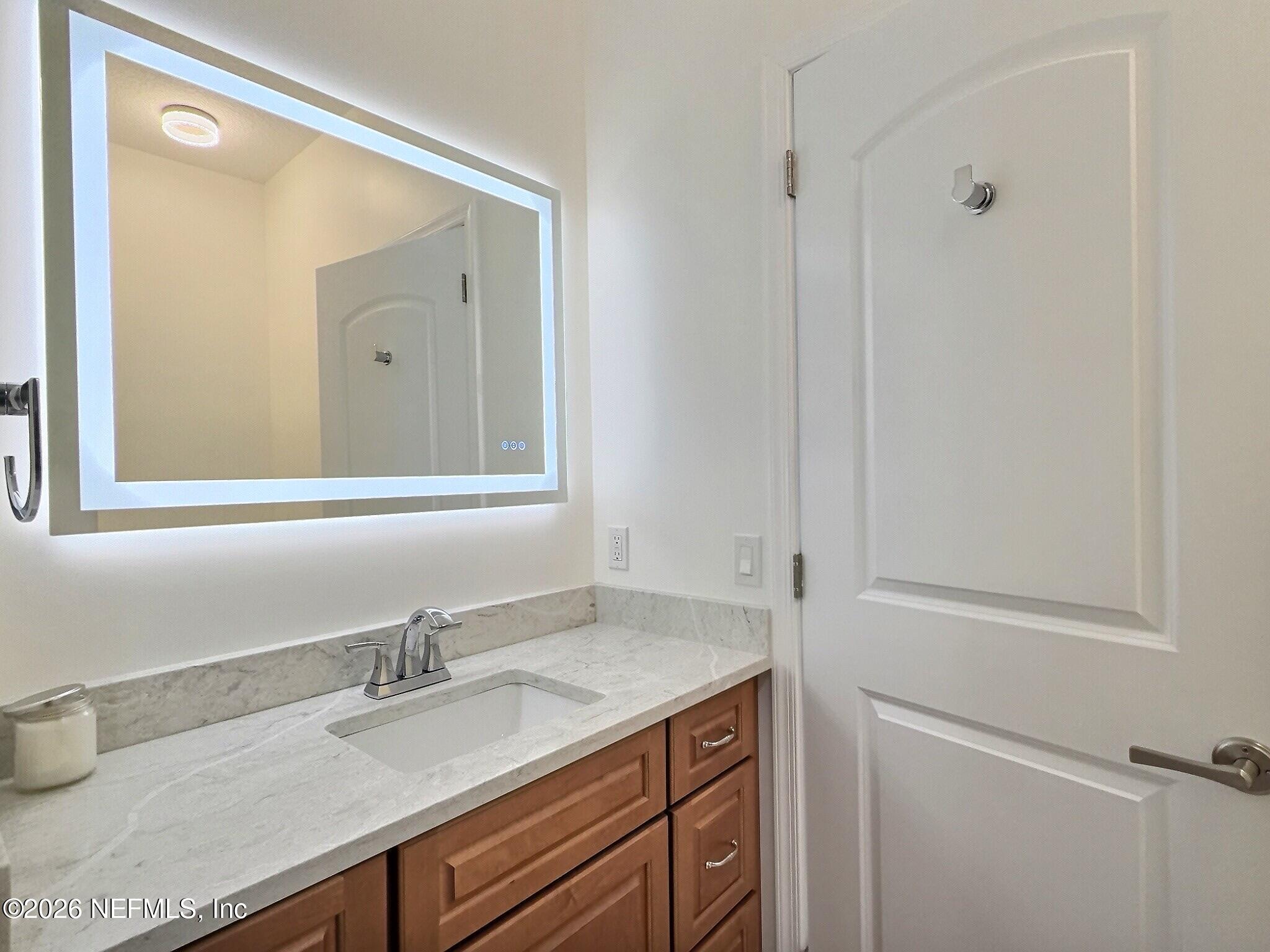 159 Mays Cove Road East Palatka, FL 32131 - Photo 28 of 62 a bathroom with a granite countertop sink and a mirror