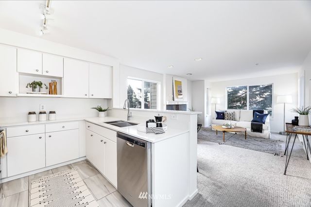 a kitchen with a sink a stove and cabinets