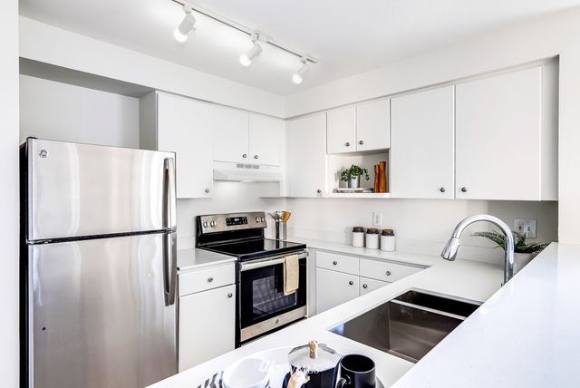 a living room with furniture a fireplace and a large window