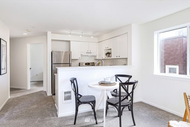 a bedroom with a bed chairs and window