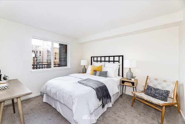 a bedroom with a bed and a lamp