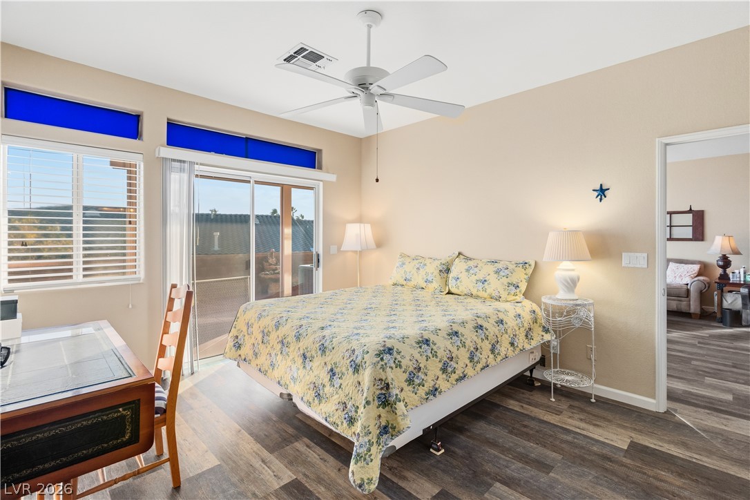3350 Pheasant Canyon Way, Unit 1008 Laughlin, NV 89029 - Photo 20 of 80 Bedroom featuring access to outside, wood finished floors, and a ceiling fan