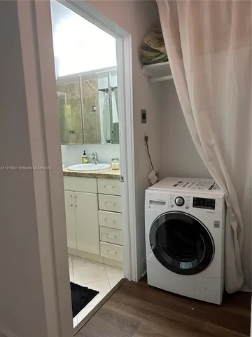 a view of a storage and utility room with washer and dryer