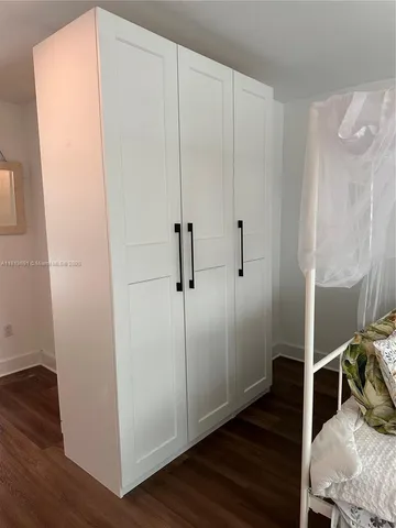 a room with wooden floor and white walls