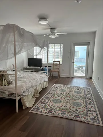a living room with hard wood floors and a rug