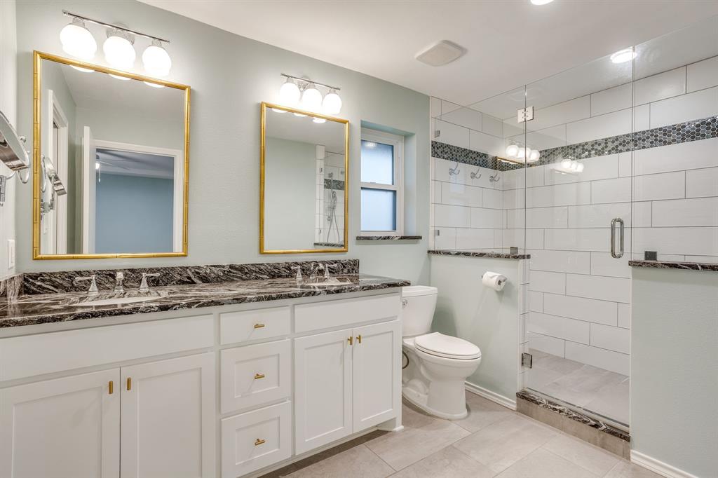 10814 Power Squadron Road Azle, TX 76020 - Photo 15 of 34 a bathroom with a double vanity sink toilet and a mirror