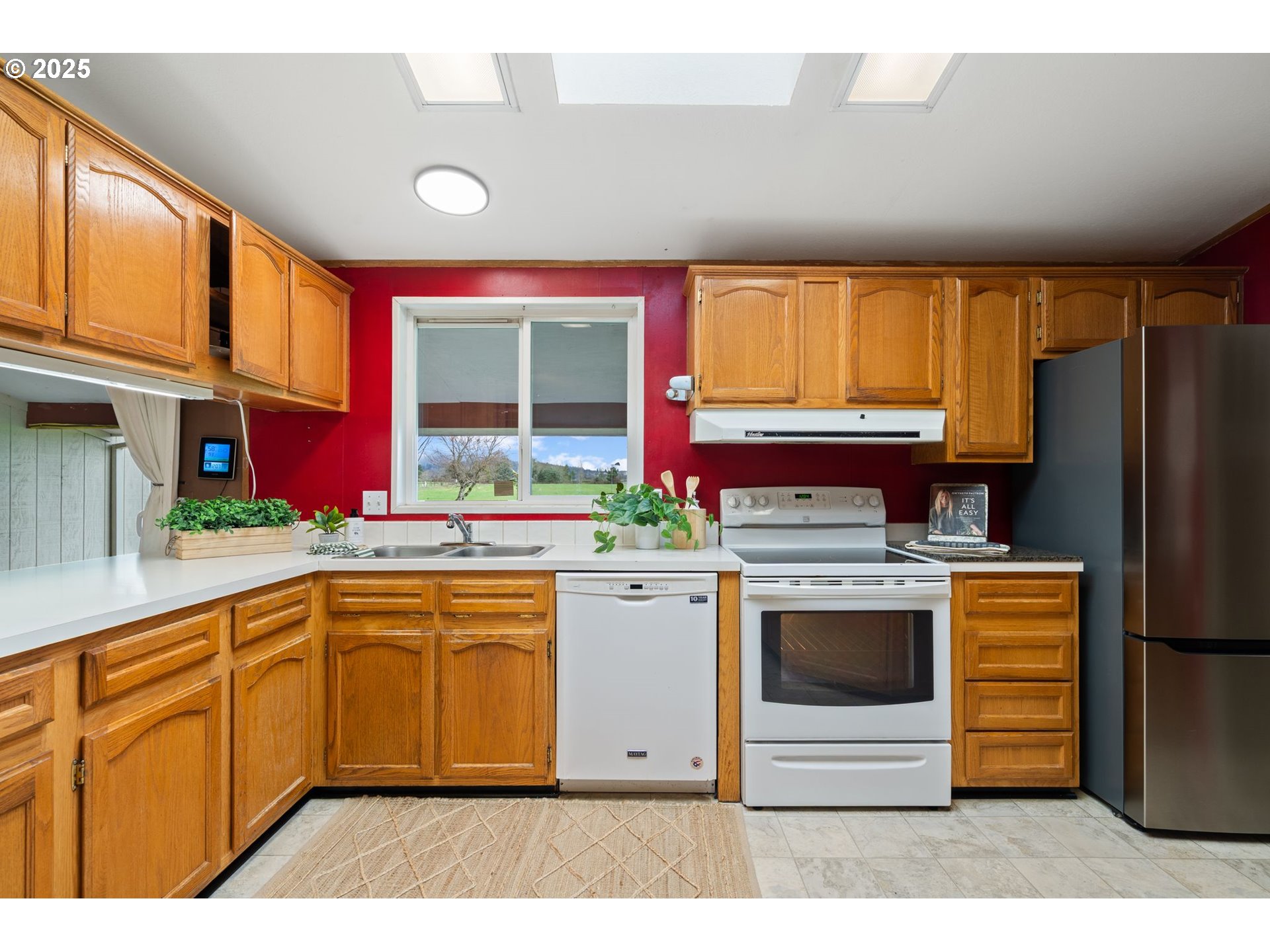 1720 Southwest Stringtown Road Forest Grove, OR 97116 - Photo 11 of 39 a kitchen with stainless steel appliances granite countertop a stove a sink dishwasher and a refrigerator