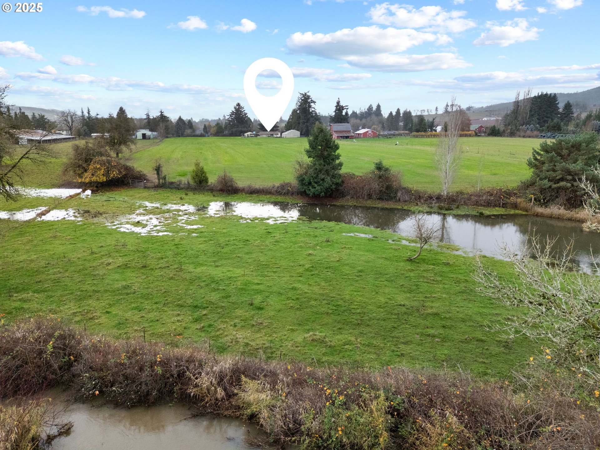1720 Southwest Stringtown Road Forest Grove, OR 97116 - Photo 36 of 39 a view of a lake with a house in the background