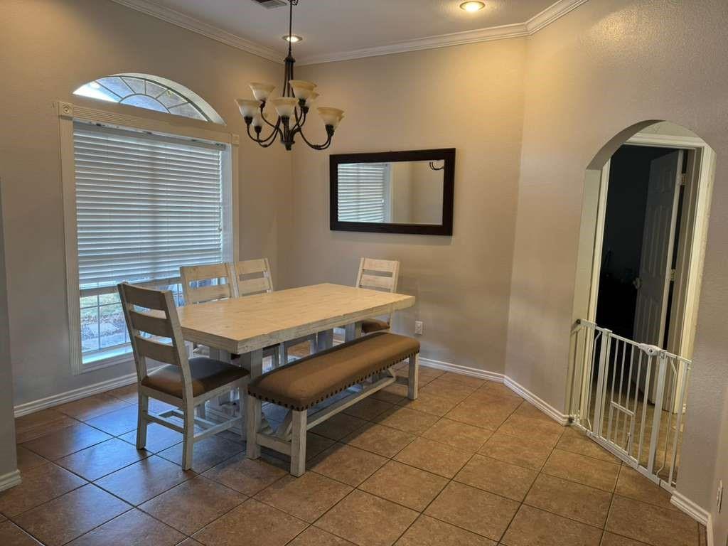 11901 Galleon Road Frisco, TX 75035 - Photo 2 of 12 a dining room with furniture and chandelier