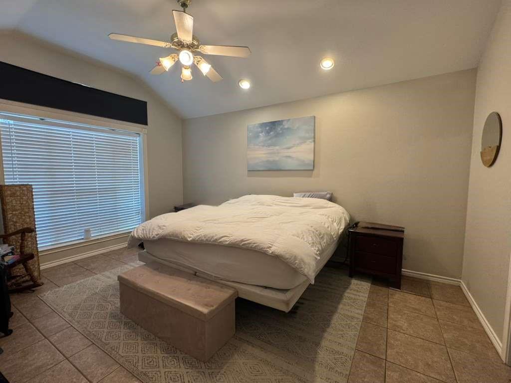 11901 Galleon Road Frisco, TX 75035 - Photo 4 of 12 a bedroom with a bed and a chandelier