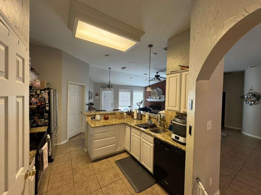 11901 Galleon Road Frisco, TX 75035 - Photo 7 of 12 a kitchen with stainless steel appliances granite countertop a refrigerator and a sink