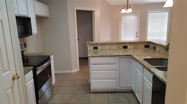 a kitchen with a sink stove and cabinets