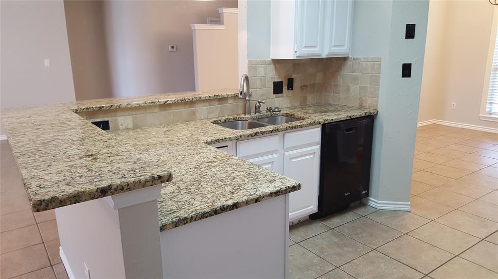 11901 Galleon Road Frisco, TX 75035 - Photo 9 of 12 a kitchen with granite countertop a sink and a stove
