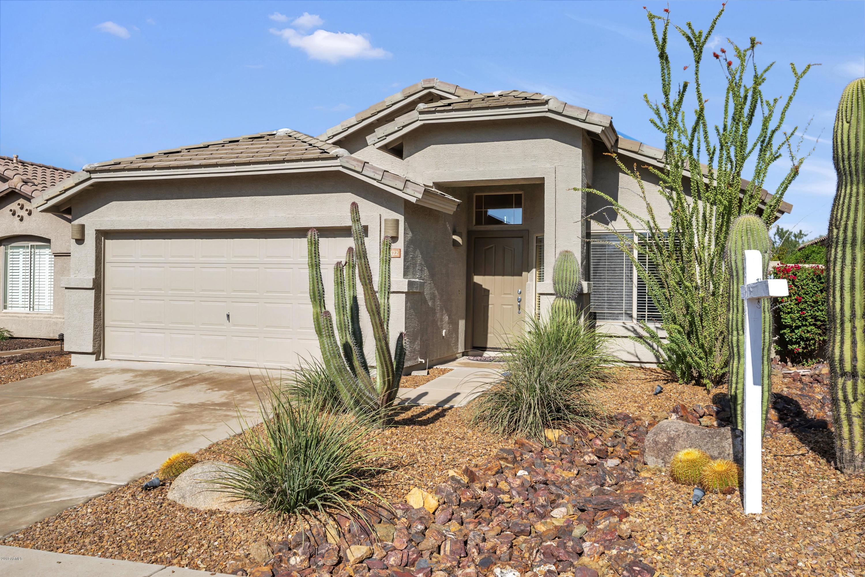 4422 East Rowel Road Phoenix, AZ 85050 - Photo 1 of 24 a front view of a house with garden