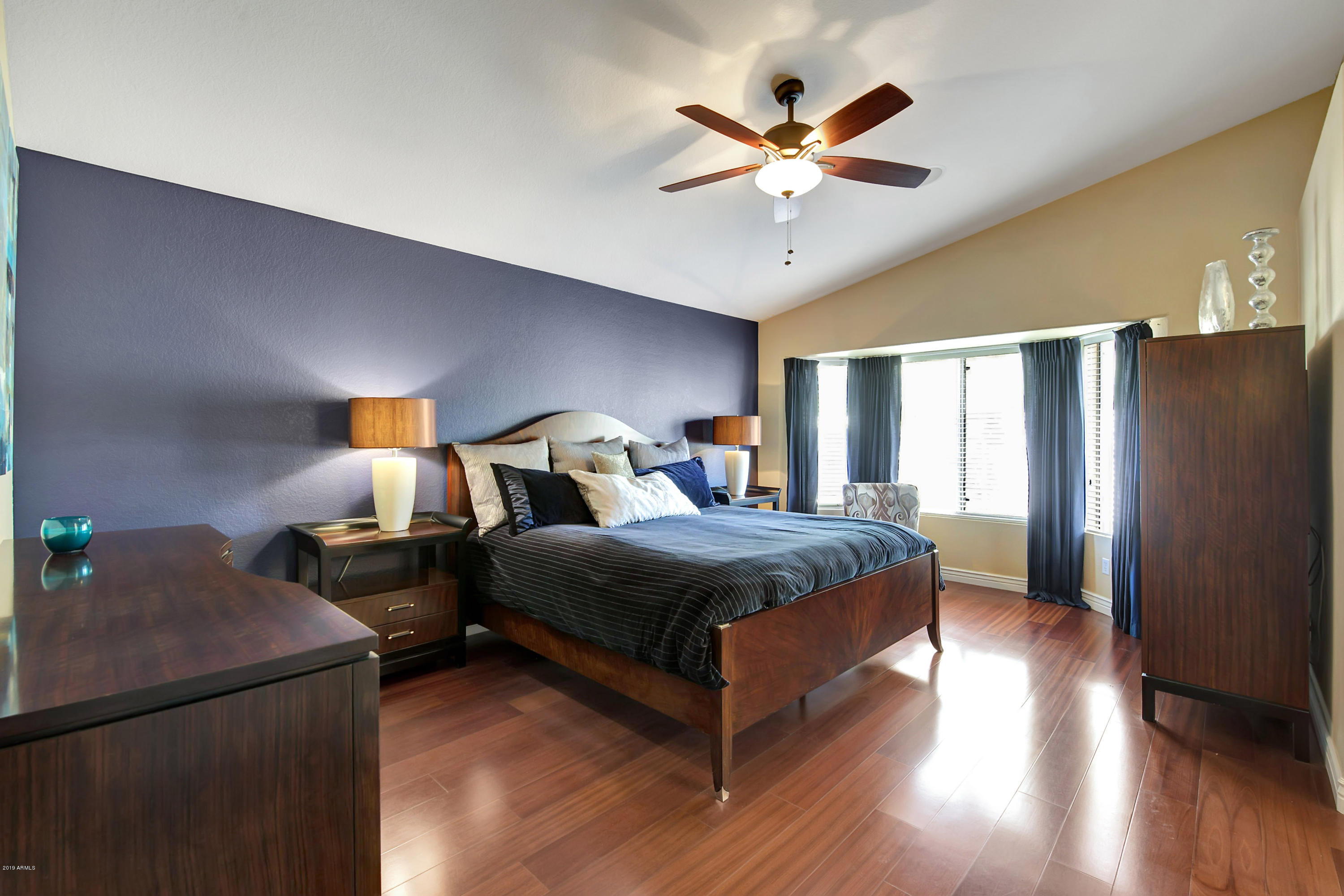 4422 East Rowel Road Phoenix, AZ 85050 - Photo 17 of 24 a bedroom with bed and wooden floor