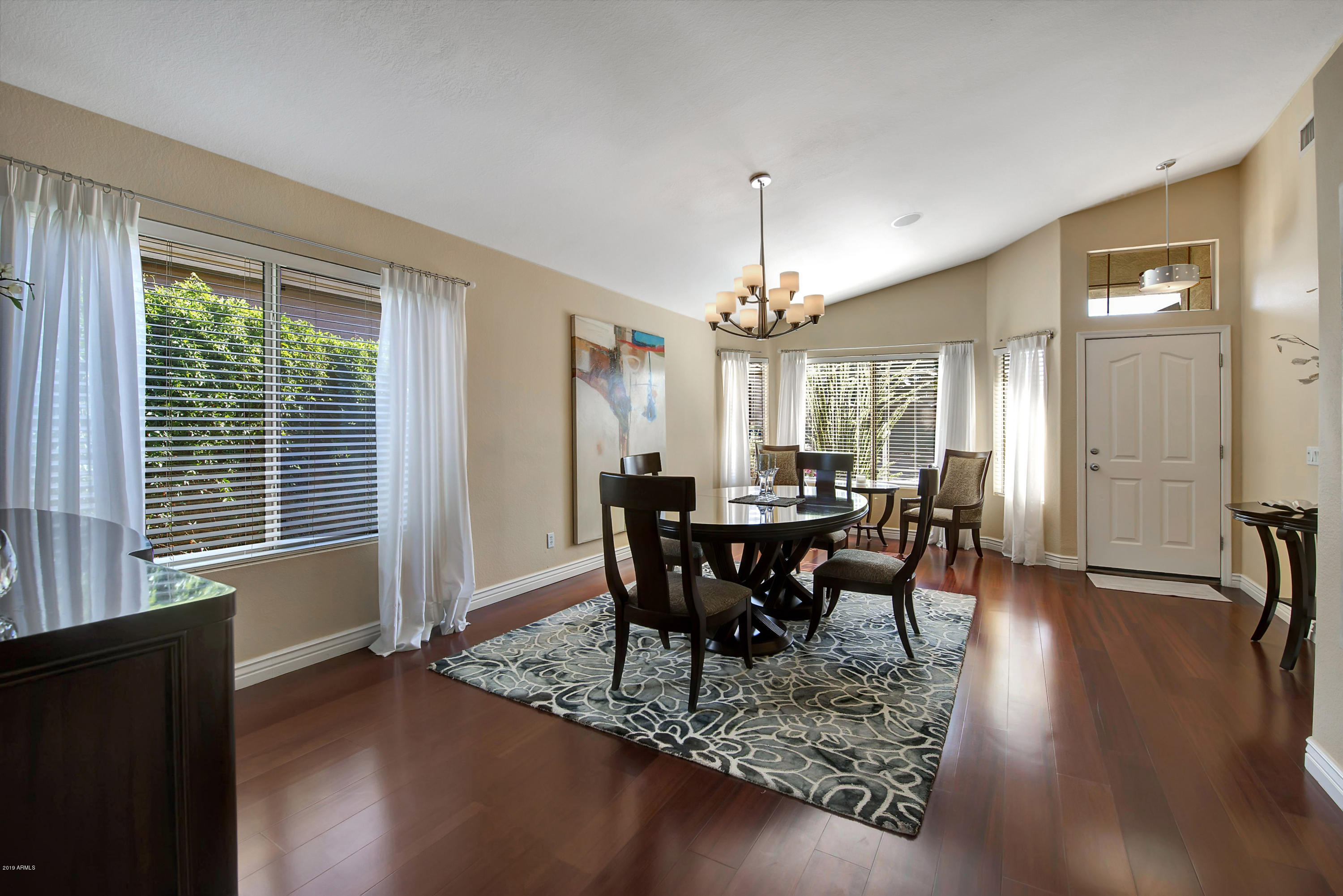 4422 East Rowel Road Phoenix, AZ 85050 - Photo 3 of 24 a view of a dining room with furniture window and wooden floor