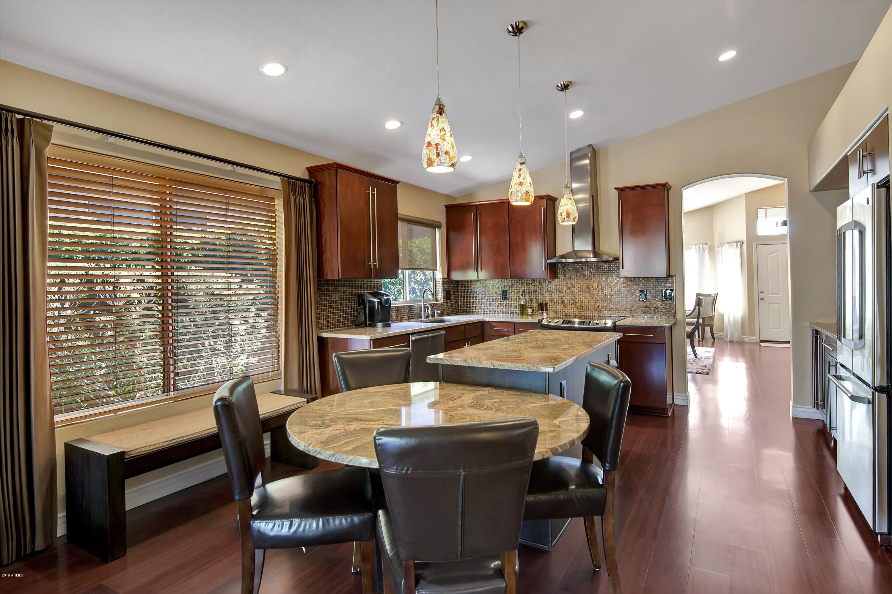 4422 East Rowel Road Phoenix, AZ 85050 - Photo 4 of 24 a view of a dining room with furniture and wooden floor
