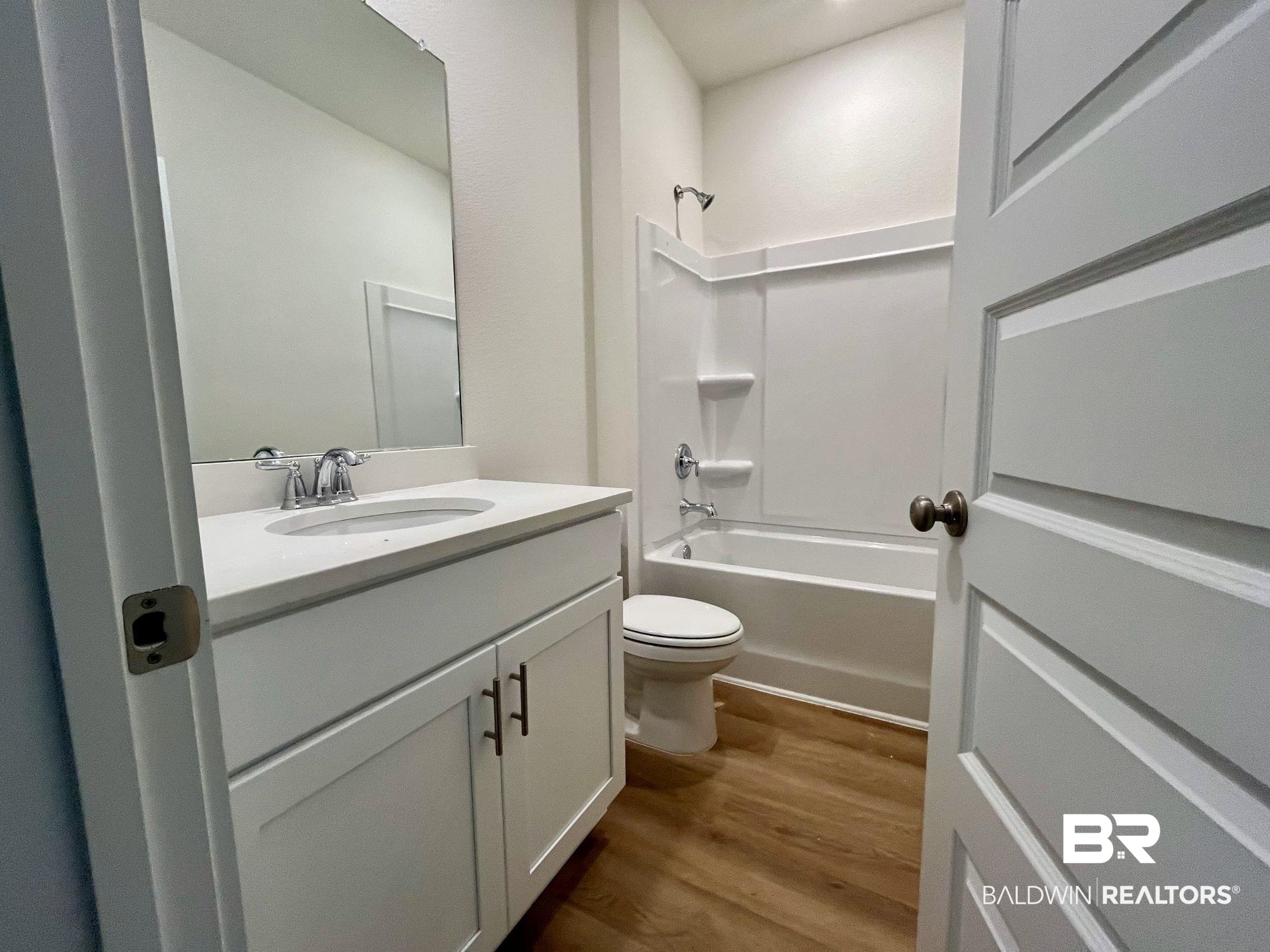 337 Barndling Street Fairhope, AL 36532 - Photo 24 of 34 Full bathroom with hardwood / wood-style floors, vanity, toilet, and shower / bathtub combination