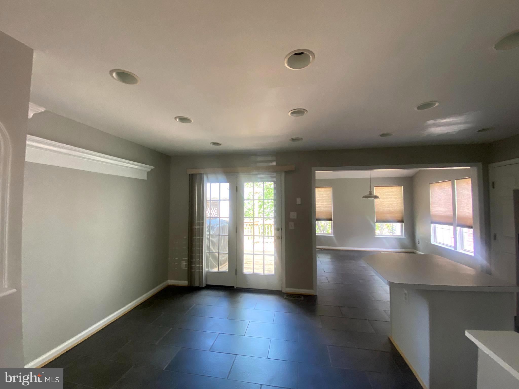 19958 Fieldgrass Square Ashburn, VA 20147 - Photo 3 of 14 an empty room with wooden floor and windows