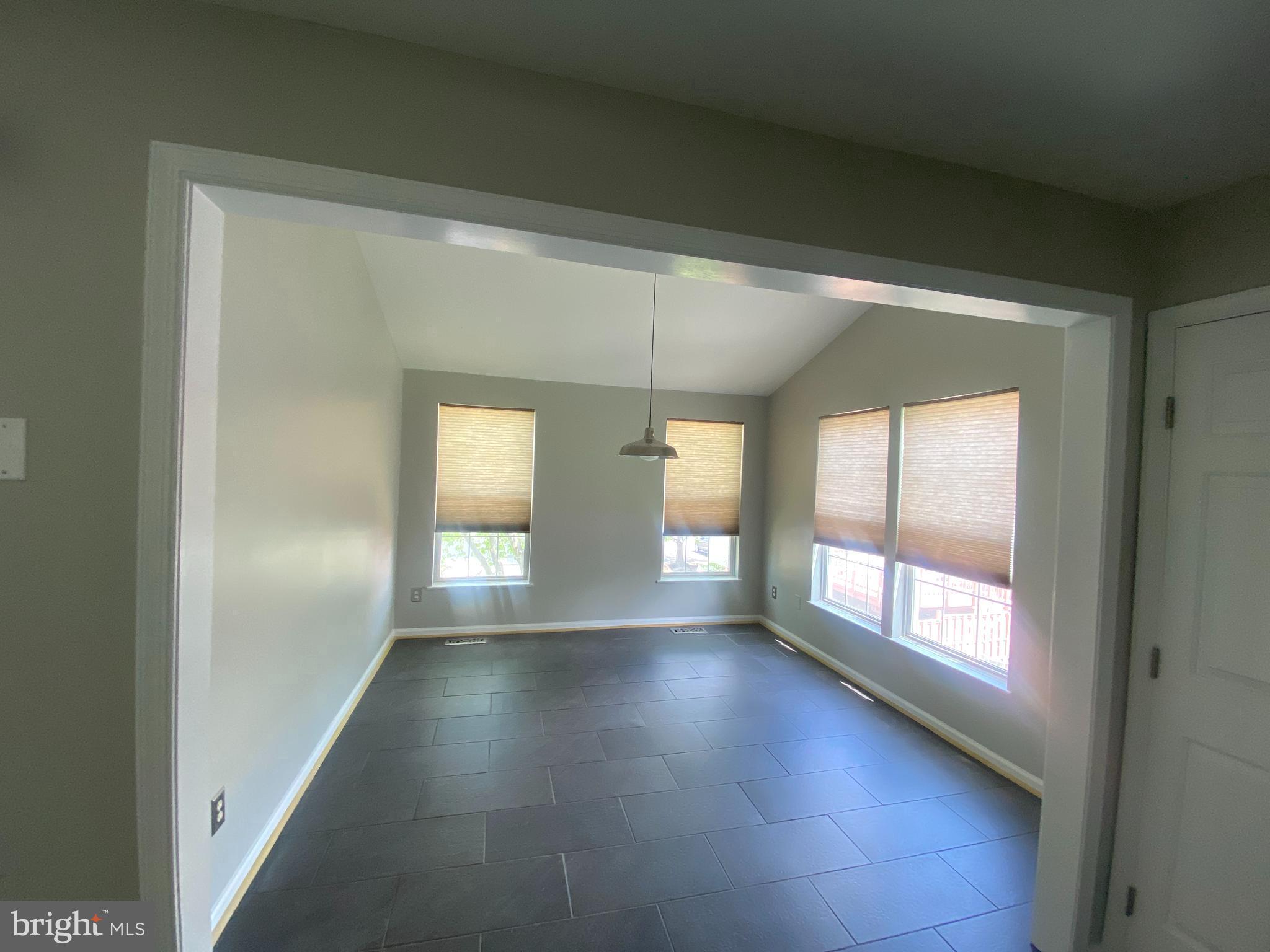19958 Fieldgrass Square Ashburn, VA 20147 - Photo 5 of 14 a view of empty room with wooden floor and fan