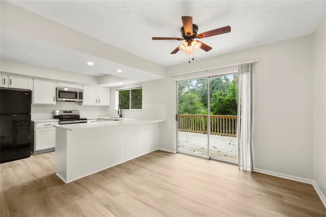 a view of a kitchen with microwave and stove