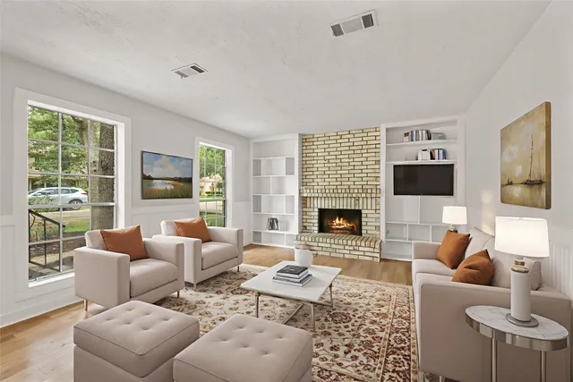 a living room with furniture fireplace and a flat screen tv