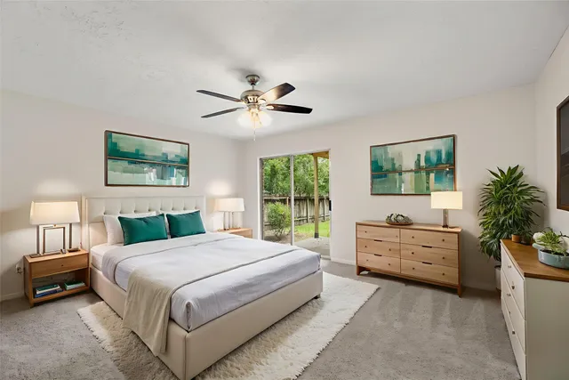 a spacious bedroom with a large bed and a chandelier