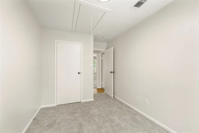 a view of a hallway with wooden floor and closet