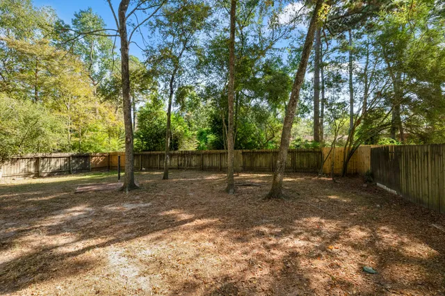 a view of a swimming pool with a table and chairs under an umbrella