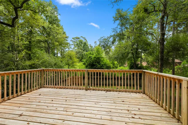 a patio with a table and chairs and potted plants