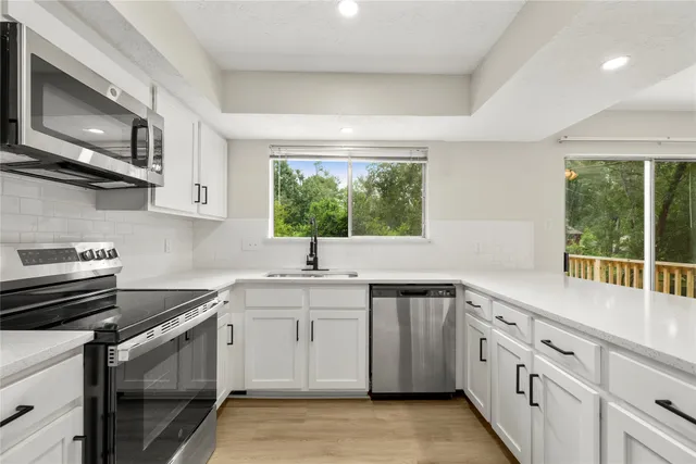 a kitchen with a sink stove and microwave