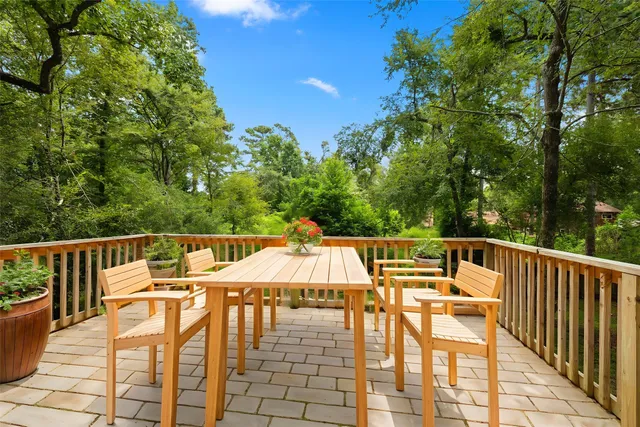 a view of deck with chairs and wooden fence