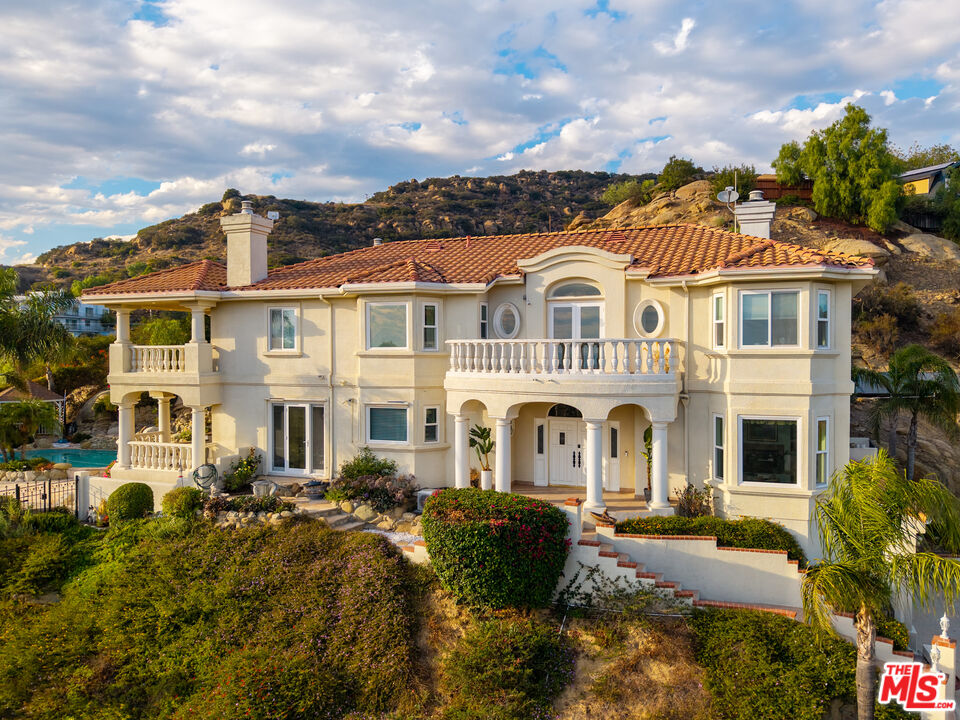 7449 Studio Road West Hills, CA 91304 - Photo 12 of 33 a front view of a residential apartment building with a yard