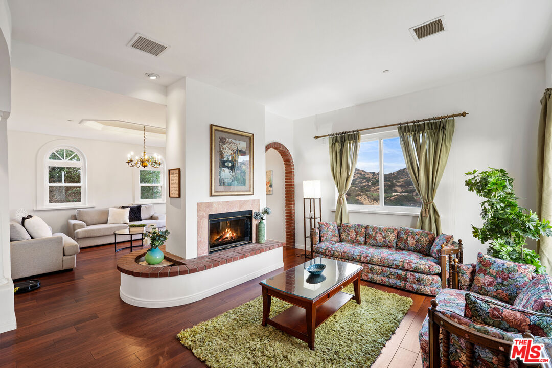 7449 Studio Road West Hills, CA 91304 - Photo 19 of 33 a living room with furniture fireplace and a large window