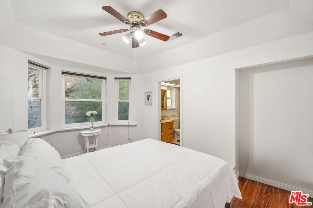 7449 Studio Road West Hills, CA 91304 - Photo 28 of 33 a bedroom with a large bed and a large window